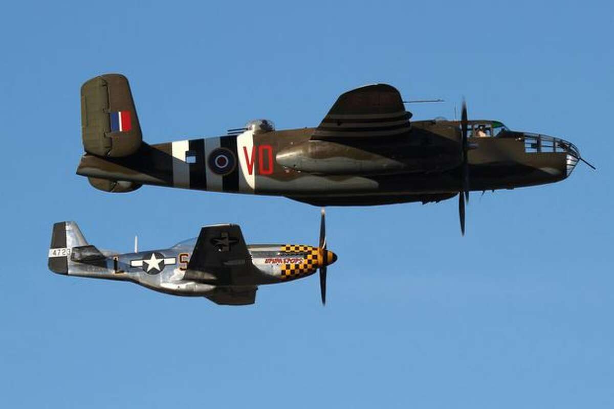 A Mitchell B-25D bomber from Everett's Historic Flight Restoration Center and a P-51 Mustang from Everett's Flying Heritage Collection fly at Boeing Field, in Seattle. (Jeremy Lindgren/NYCAviation.com)