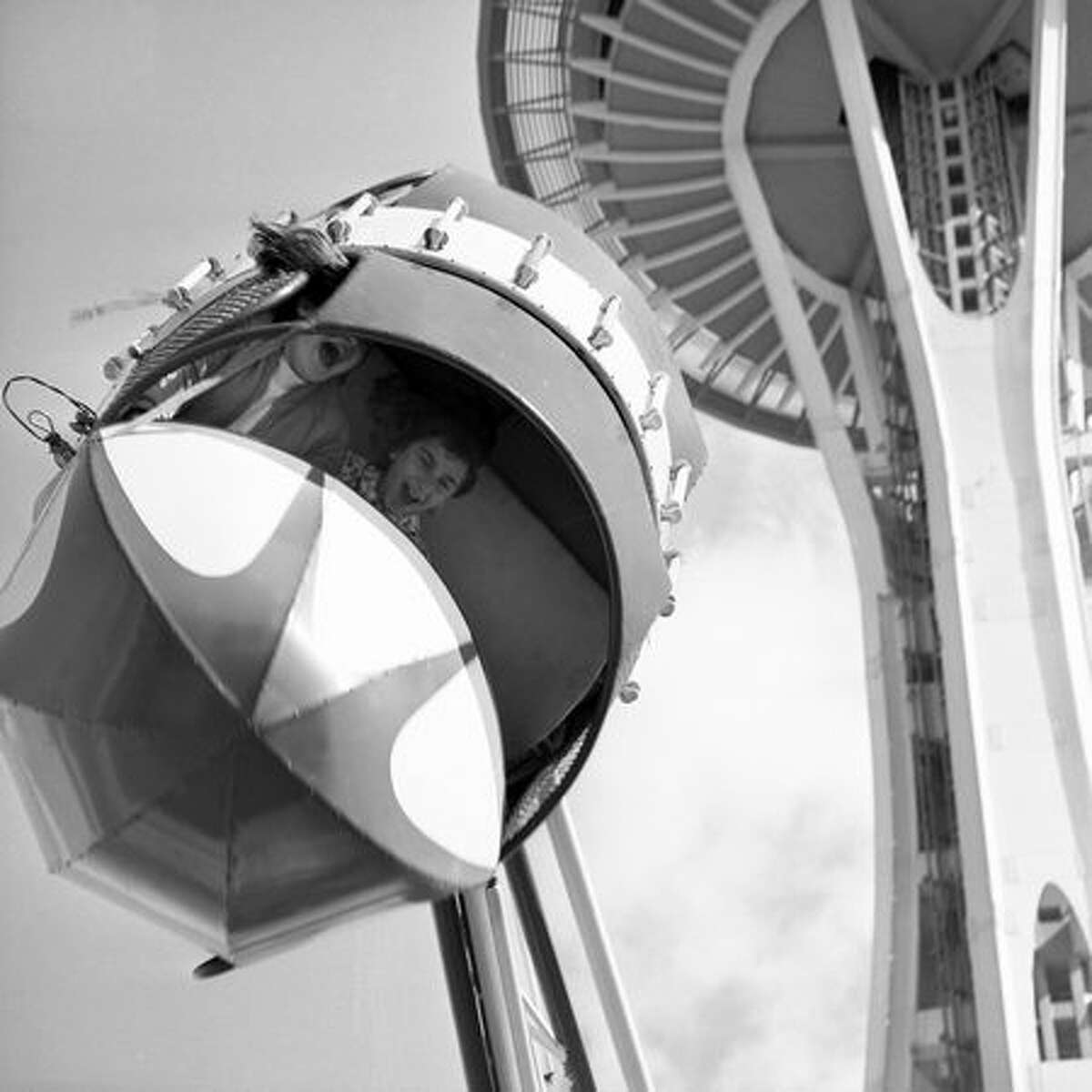 The Seattle Center's Fun Forest, which was initially formed as the Gayway entertainment area for the 1962 World's Fair, added major rides in 1964 to what had been primarily an assortment of carnival games. In this spring 1965 photo, Mary Anne Norton, age 13, and Kristy Davis, 12, enjoy the Rolo Plane. (Seattlepi.com file/MOHAI collection)