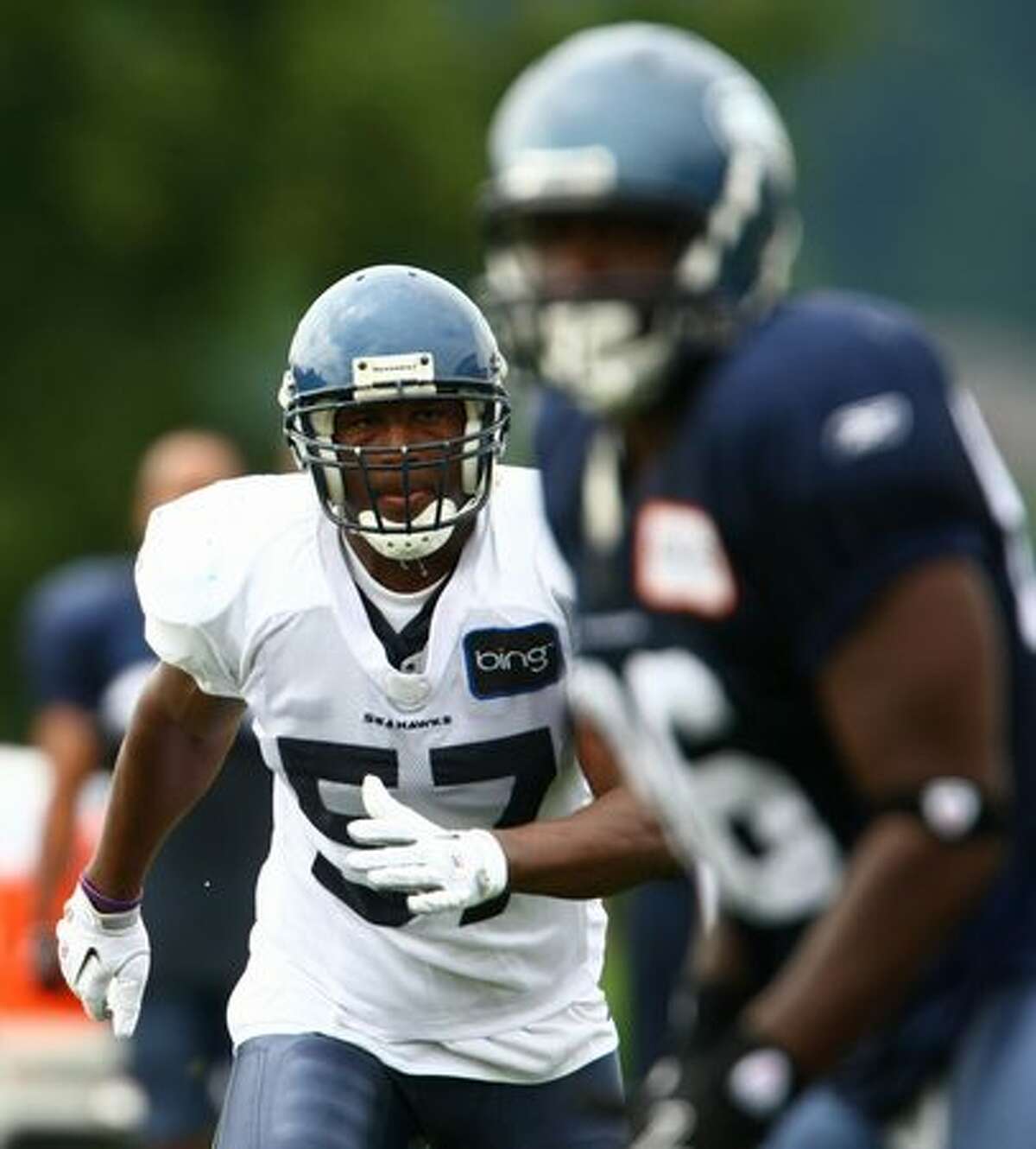Seattle Seahawk David Hawthorne (57) practices with teammates.
