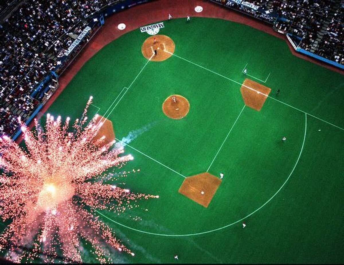 This photo, shot from the roof of the Kingdome, shows a firework exploding as Seattle Mariners David Segui rounds 2nd base. Segui had a sixth inning home run against the Texas Rangers, June 25, 1999.