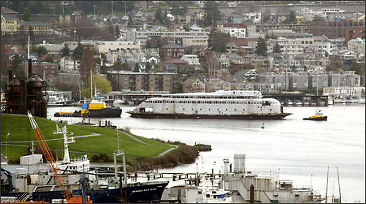 A tug pulls the vintage ferry Kalakala away from its moorage at Gas Works Park on Lake Union.