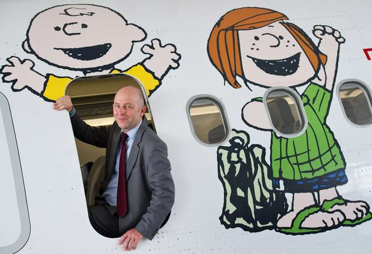 Uwe Balser, chairman of German airline Condor, poses in the door of an airplane decorated with protagonists of the U.S. comic strip "Peanuts" on June 10, 2010 at the International Aerospace Exhibition at the Schoenefeld airport in Berlin.