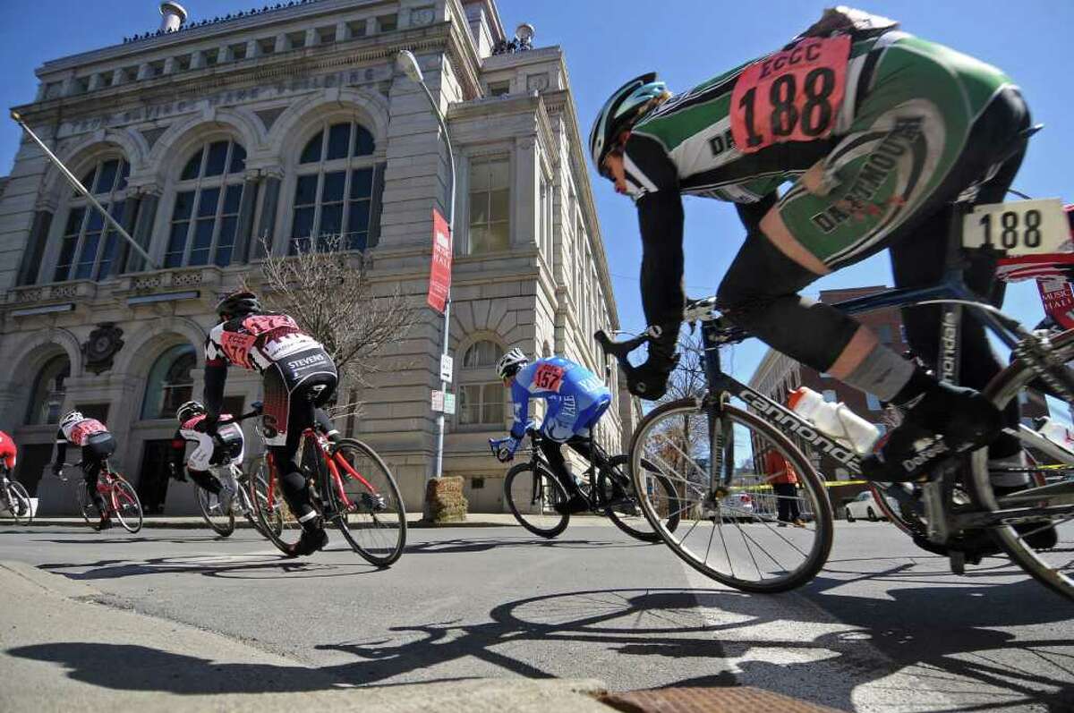 Dartmouth's Zachary Parket, right, shows signs of an earlier spill on his left thigh, while turning from State Street onto 2nd Street across from the Troy Savings Bank Music Hall building during the Men's B race of the Tour de Troy on Sunday March 27, 2011 in Troy. ( Philip Kamrass/ Times Union )