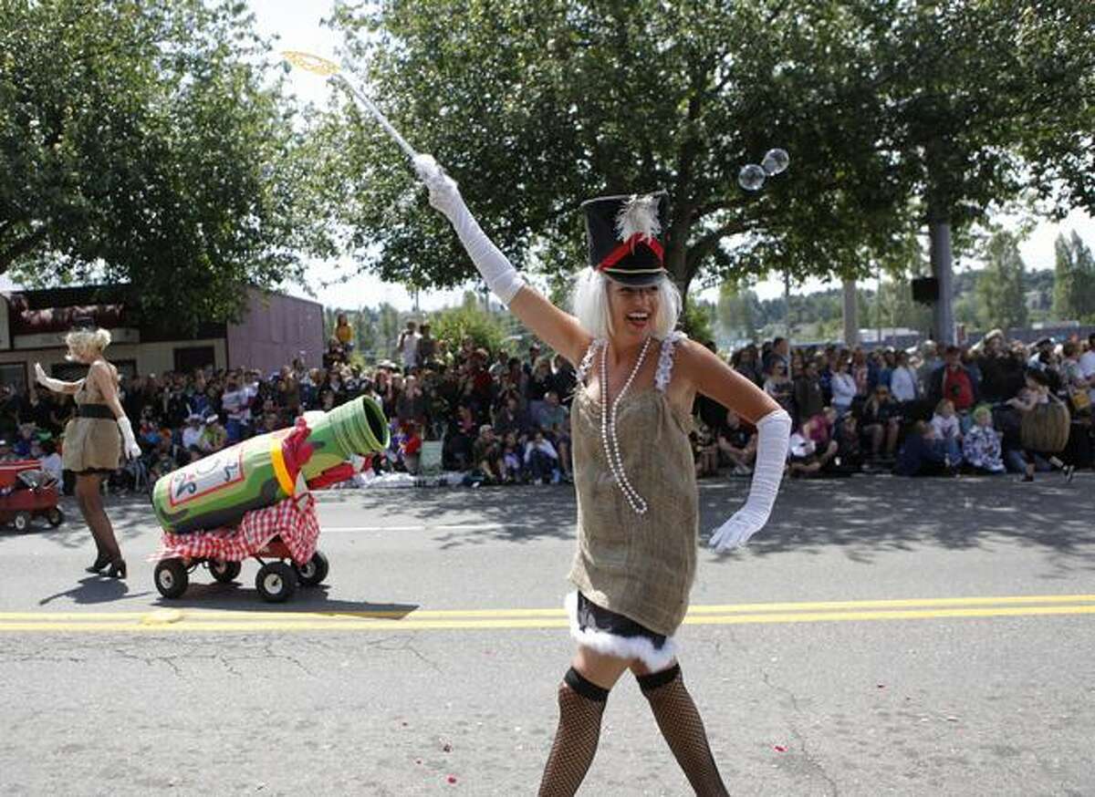 A bubble-making parade participant smiles to the crowd during the Fremont Solstice Parade.