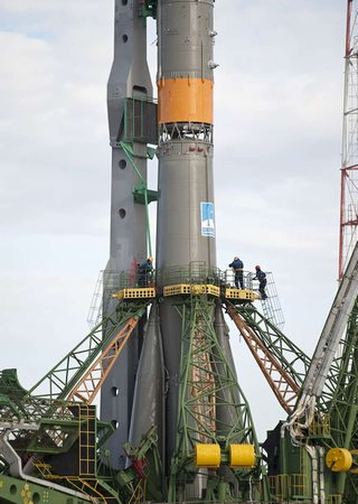 Pad technicians secure the Soyuz TMA-18 spacecraft shortly after it was rolled out by train to the launch pad at the Baikonur Cosmodrome,in Kazakhstan, on March 31, 2010. The launch of the Soyuz spacecraft with Expedition 23 Soyuz Commander Alexander Skvortsov of Russia, Flight Engineer Mikhail Kornienko of Russia, and NASA Flight Engineer Tracy Caldwell Dyson is scheduled for Friday, April 2, 2010.
