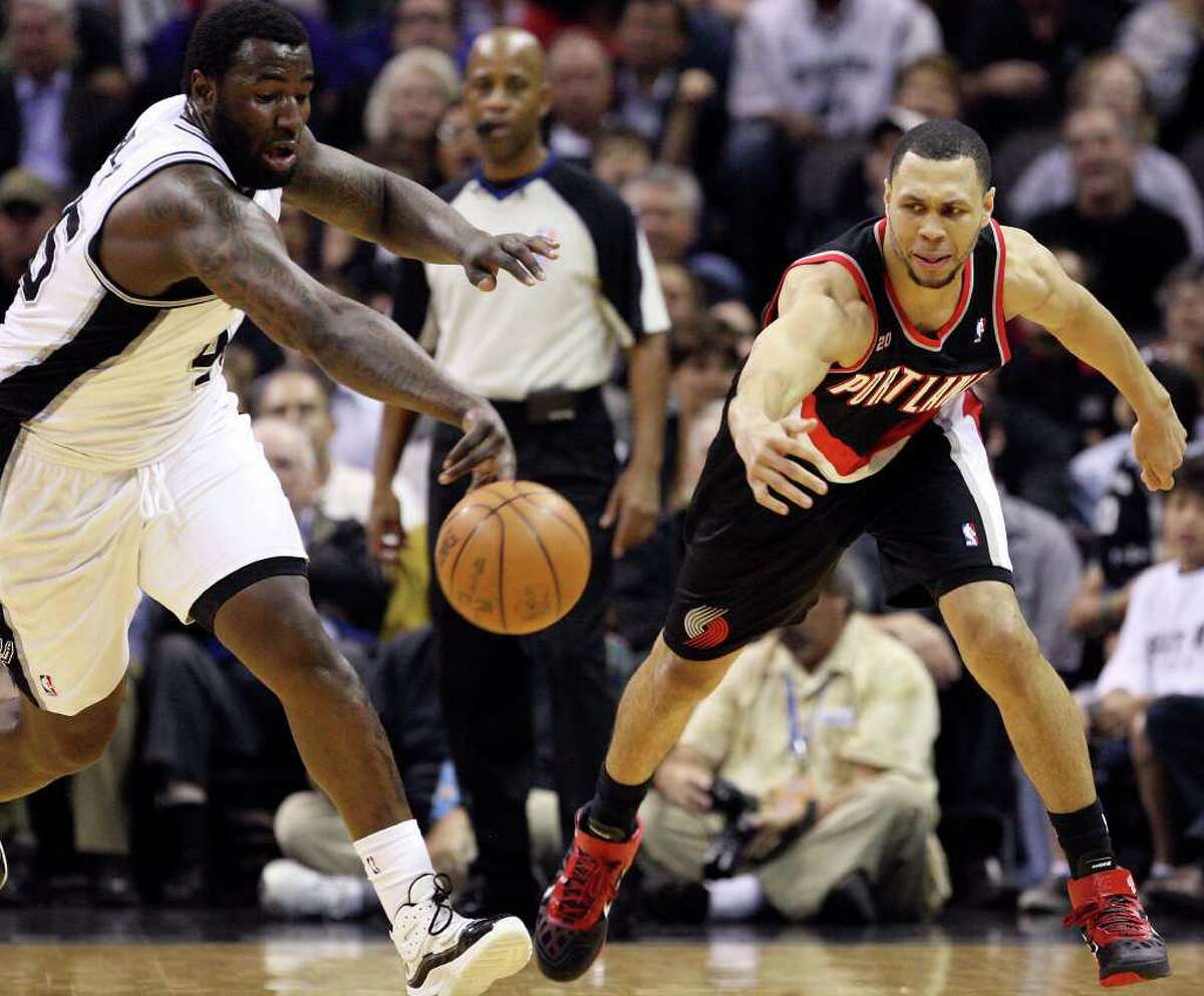 FOR SPORTS - Spurs' DeJuan Blair and Trail Blazers' Brandon Roy grab for a loose ball during first half action Monday March 28, 2011 at the AT&T Center. (PHOTO BY EDWARD A. ORNELAS/eaornelas@express-news.net)