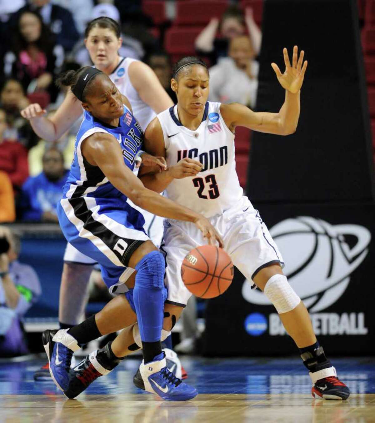 Duke's Karima Christmas, left, battles for control of the ball against Connecticut's Maya Moore (13) in the first half of an NCAA women's college basketball tournament regional final, Tuesday, March 29, 2011, in Philadelphia. (AP Photo/Barbara Johnston)