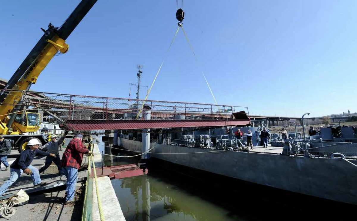 Volunteers guide the gangway to the USS Slater after it was moved from its winter dock on the Rensselaer side of the Hudson River to its seasonal home on the Albany side on March 30, 2011. (Skip Dickstein / Times Union)