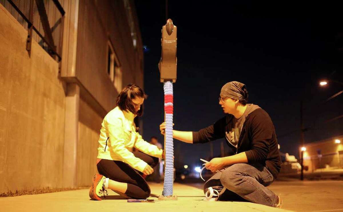****NOTE TILDE OVER N IN MUNOZ****** FOR SALIFE - Claudia Rubio (left) and Billy Muñoz knits together a parking meter koozie Monday March 7, 2011 on Grayson Street part of the Yarn Dawgz "Knit, Purl, Knit, Pearl (Brewery)" installation for Contemporary Art Month. (PHOTO BY EDWARD A. ORNELAS/eaornelas@express-news.net)