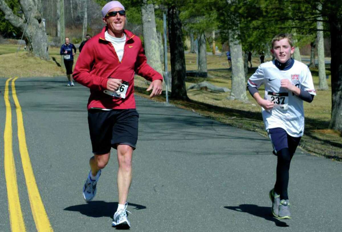 SPECTRUM/Veteran runner Scott Knight of New Milford hustles to keep pace with his son, Connor, during March 20's 28th edition of the Polar Bear Run road race around Lake Waramaug.