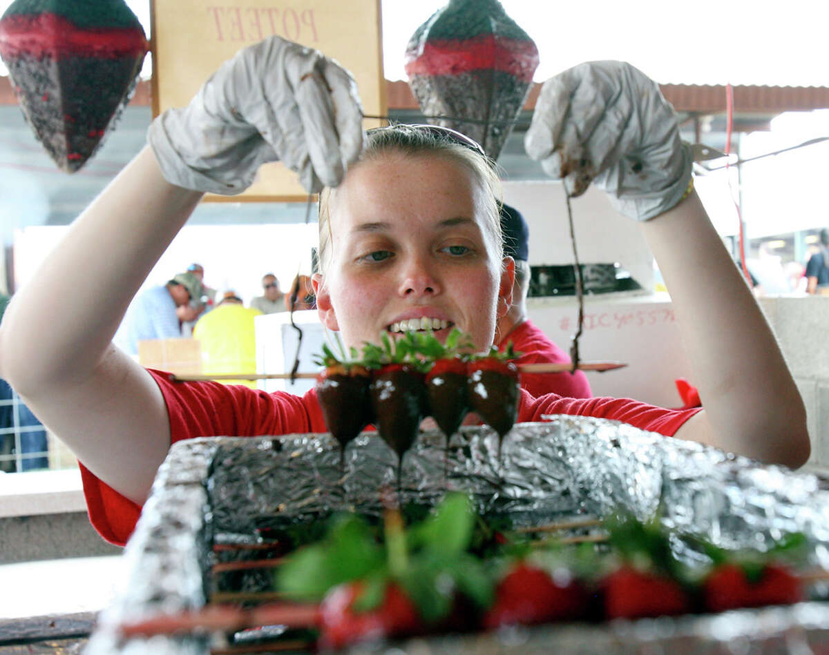 Rene Walls prepares chocolate-dipped strawberries during last year's Poteet Strawberry Festival. EDWARD A. ORNELAS / EXPRESS-NEWS