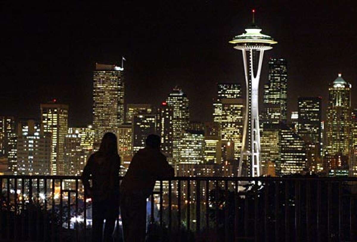 Just after sunset a couple stops to take in the view of Seattle's skyline from Kerry Park on Queen Anne Hill. (Gilbert W. Arias / Seattle P-I)
