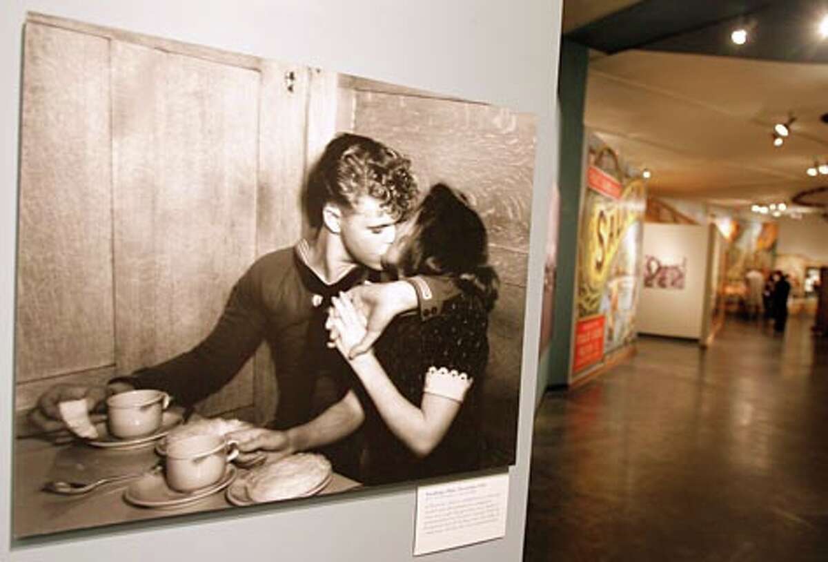 Sneaking a Kiss, December 1944, a photo from MOHAI Seattle P-I collection in the World War II exhibit at the Museum of History in December 2006. (Gilbert W. Arias / Seattle P-I)