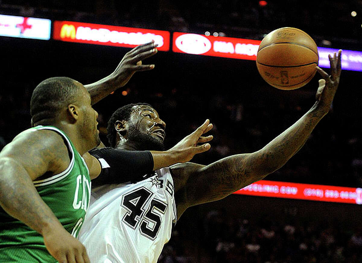 DeJuan Blair (45) of the Spurs and Glen Davis of the Celtics battle for a rebound at the AT&T Center on Thursday. BILLY CALZADA / gcalzada@express-news.net
