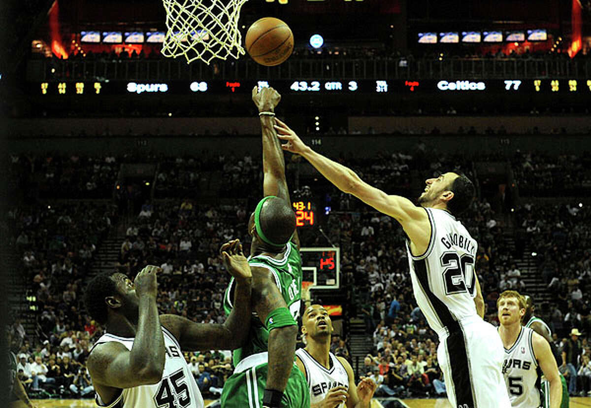 Manu Ginobili of the Spurs (right) and teammate DeJuan Blair battle Jermaine O'Neal of the Celtics for a rebound at the AT&T Center on Thursday. BILLY CALZADA / gcalzada@express-news.net