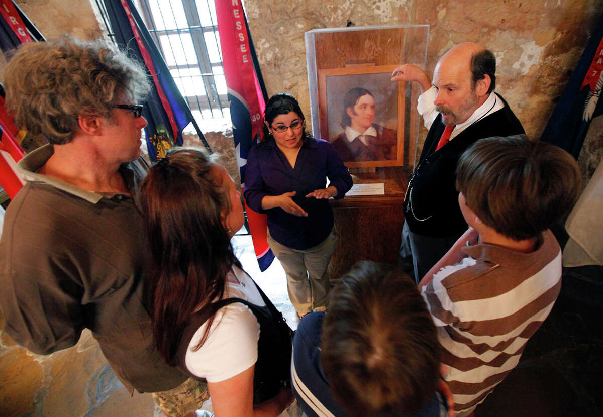 Deaf couple Bruce and Gail Fearing (right) and their two sons, Adam (pictured) and Joshua, are given a tour of the Alamo with the use of an American Sign Language interpreter Cassandra Ramirez (left) and Alamo curator Bruce Winders.