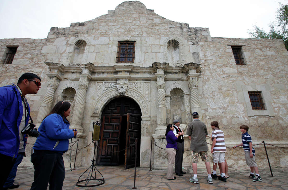 Standing outside the front of the Alamo, deaf couple Bruce and Gail Fearing and their two sons, Adam and Joshua, are given a tour of the Alamo with the use of an American Sign Language interpreter Cassandra Ramirez and Alamo curator Bruce Winders.