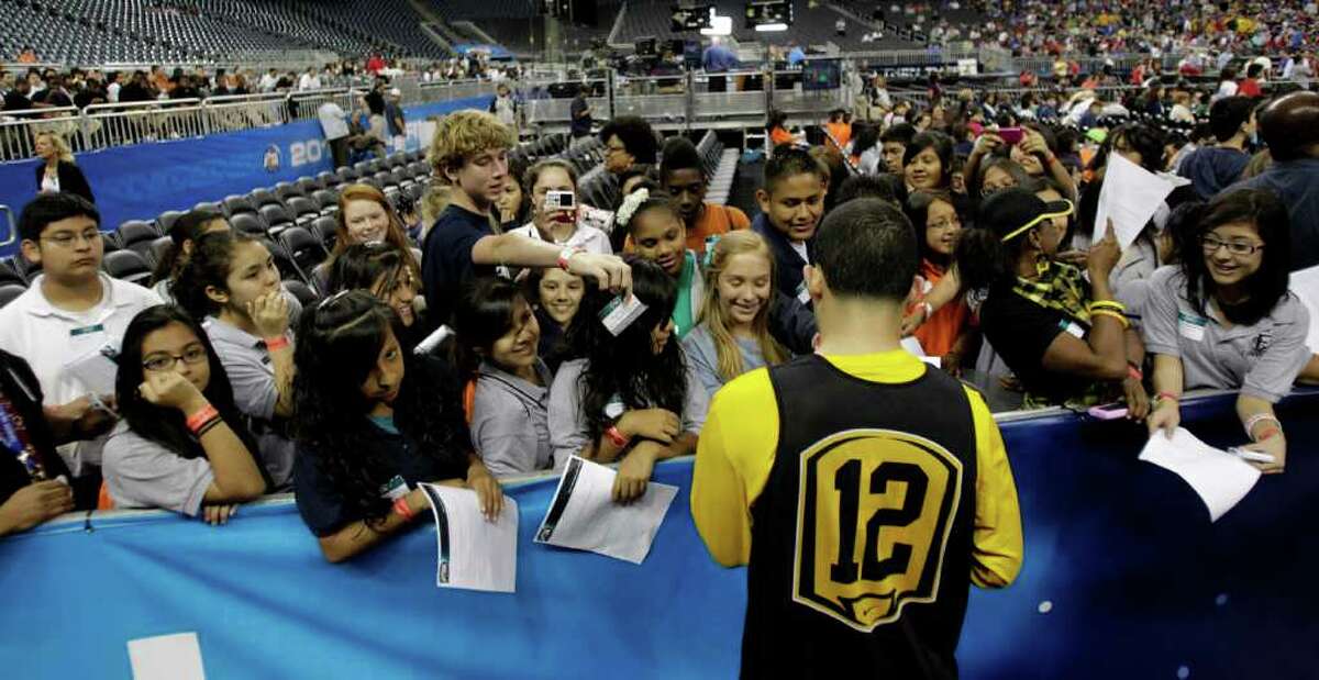 Virginia Commonwealth guard Joey Rodriguez (12) signs autographs after VCU's open practice at Reliant Stadium, Friday, April 1, 2011, in Houston, as teams prepare for the Final Four games to begin. ( Karen Warren / Houston Chronicle )