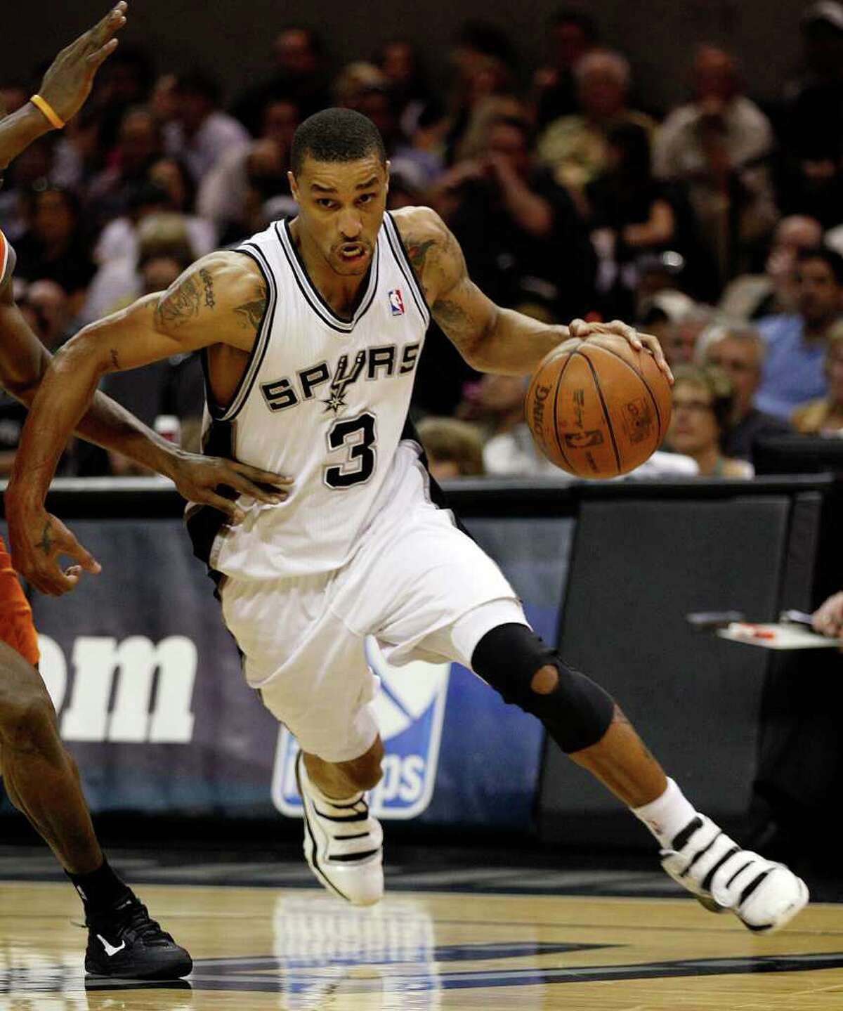 SPURS -- San Antonio Spurs George Hill drives to the goal past Phoenix Suns Zabian Dowdell during the second half at the AT&T Center, Sunday, April 3, 2011. The Spurs won 114-97 and Hill ended up 29 points. JERRY LARA/glara@express-news.net