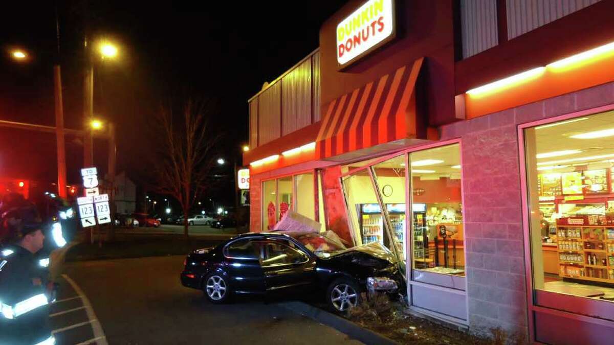 The Norwalk Fire Department responded to a car into a building this morning just after 2:30 am. Two patrons sitting at a table inside the Dunkin Donuts, located at 195 Main Avenue Norwalk were struck and thrown across the floor when the car hit the building. The Nissan Maxima's left front tire came to rest at the spot where the patrons table was located.