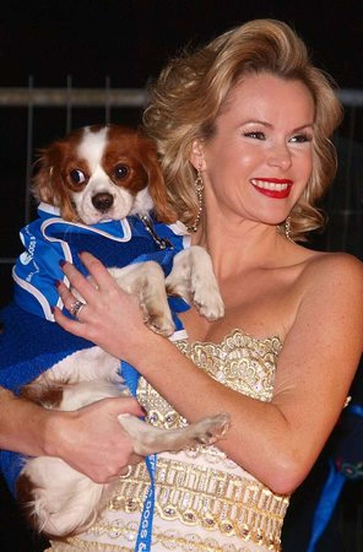 British actress Amanda Holden poses for pictures with 'Nancy,' a long haired Chihuahua, as she arrives for a charity ball to celebrate the 150th anniversary of the Battersea Dogs home, in London, on November 25, 2010.