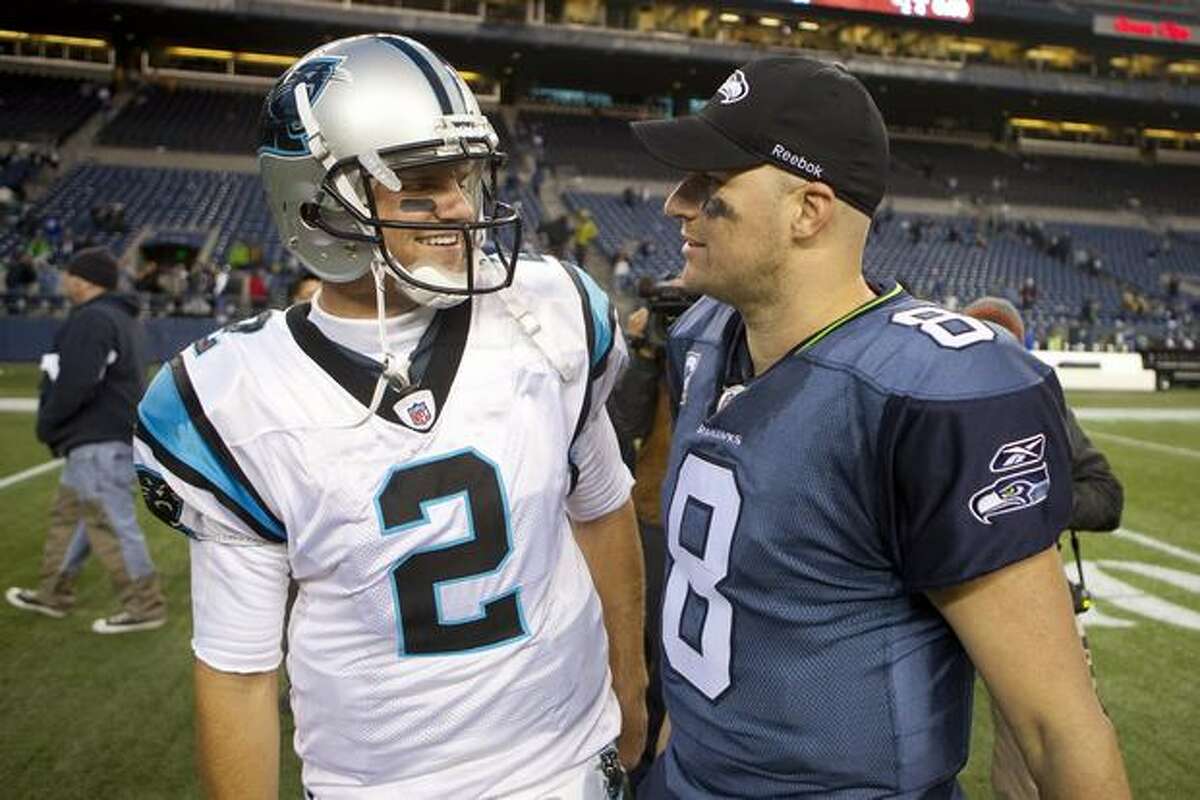 Carolina quarterback Jimmy Clausen (left) and the Seahawk's Matt Hasselbeck meet up after the game that was won by the Seahawks.