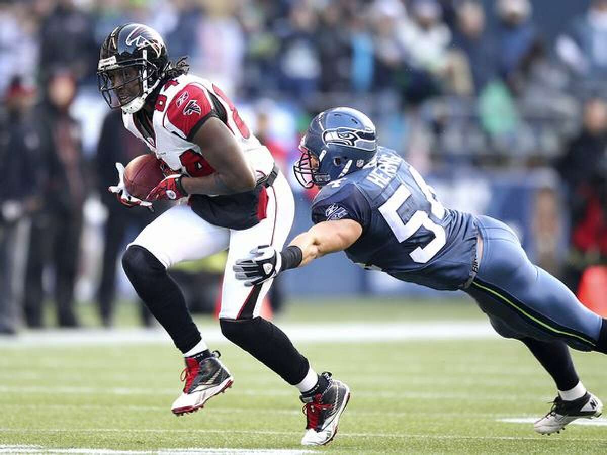 Wide receiver Roddy White #84 of the Atlanta Falcons rushes against Will Herring #54 of the Seattle Seahawks.