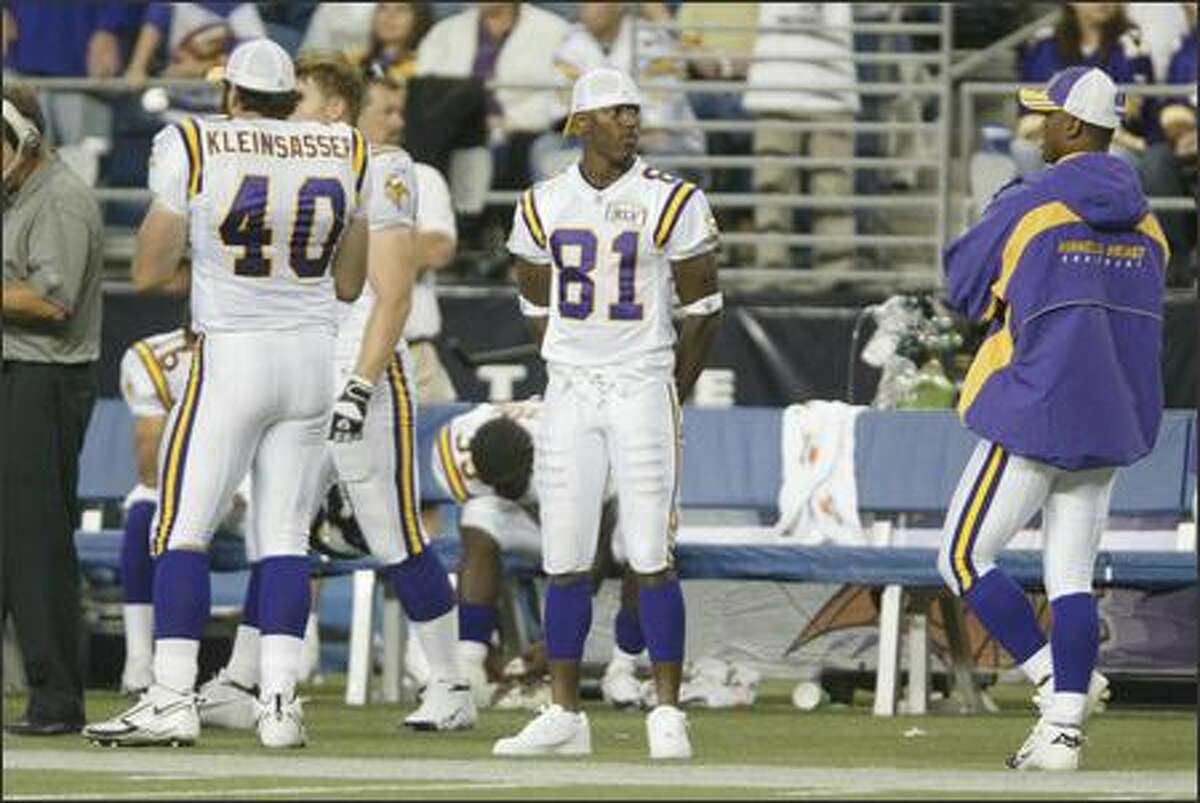 Minnesota Vikings' Nate Burleson stands on the sidelines during fourth quarter action.