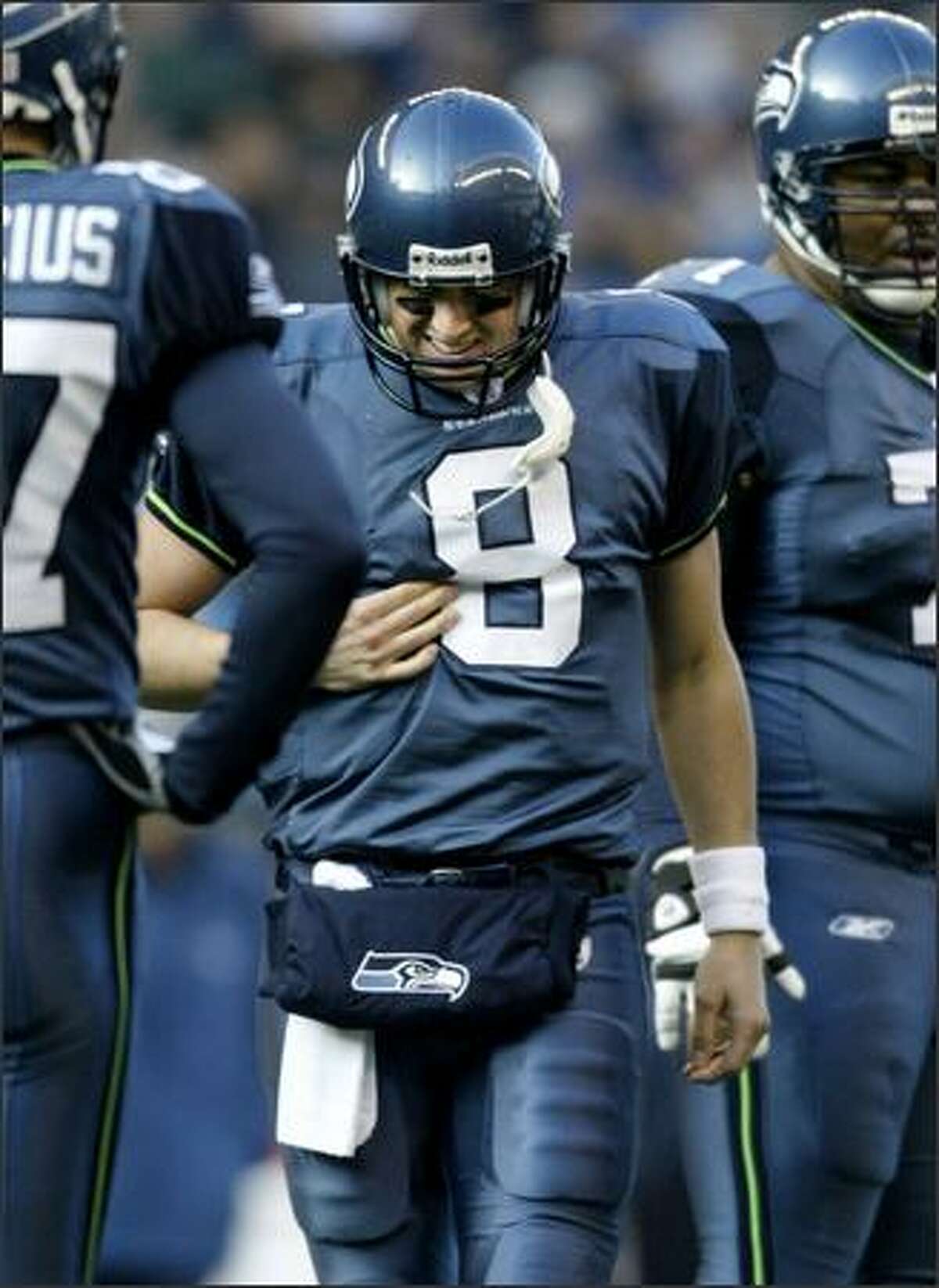 Seahawks quarterback Matt Hasselbeck holds his ribs after being hit by San Francisco 49ers linebacker Derek Smith during the first quarter. Smith was called for roughing the passer.