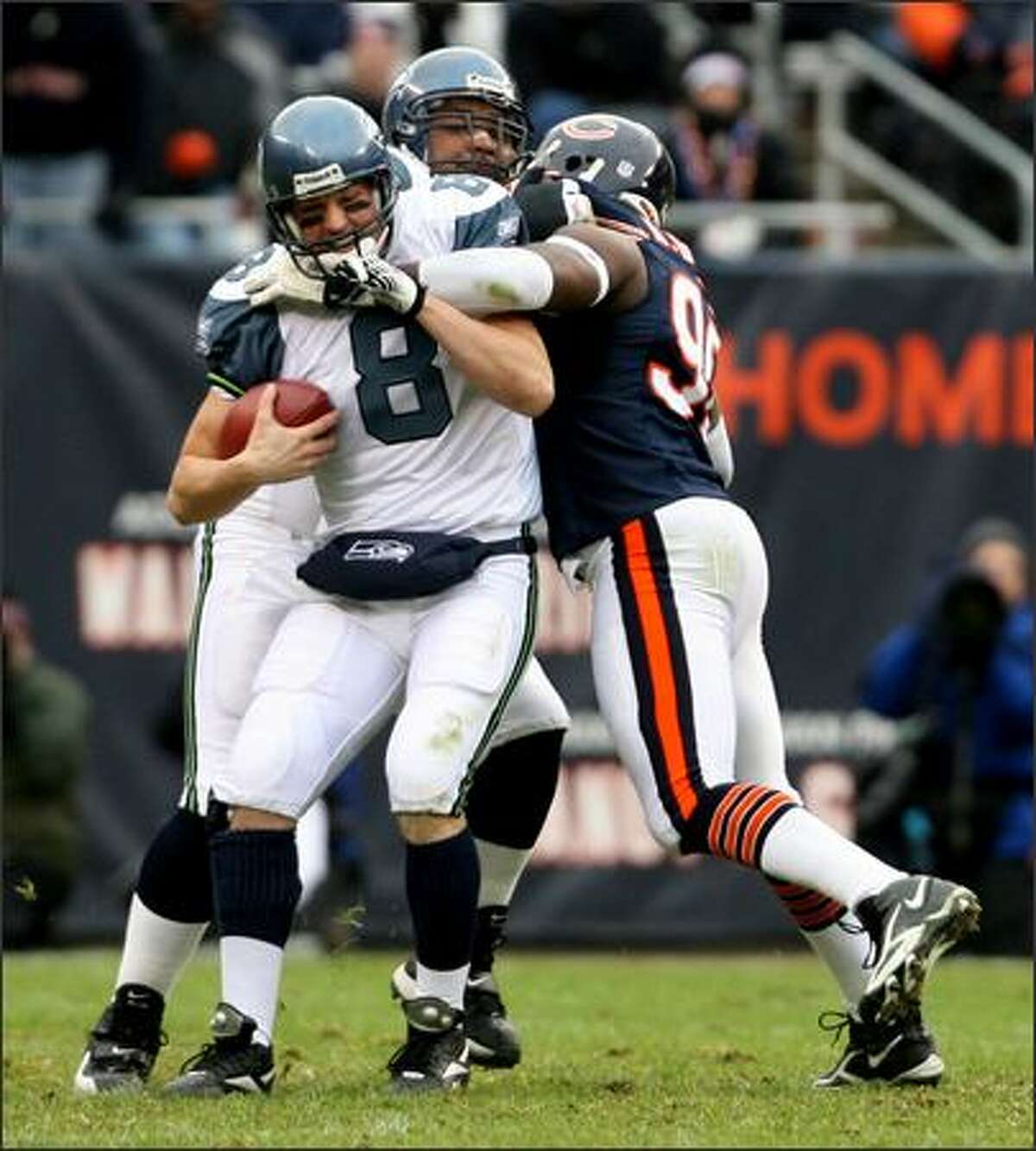 Matt Hasselbeck gets sacked near the end of the first half by Chicago's Alex Brown.