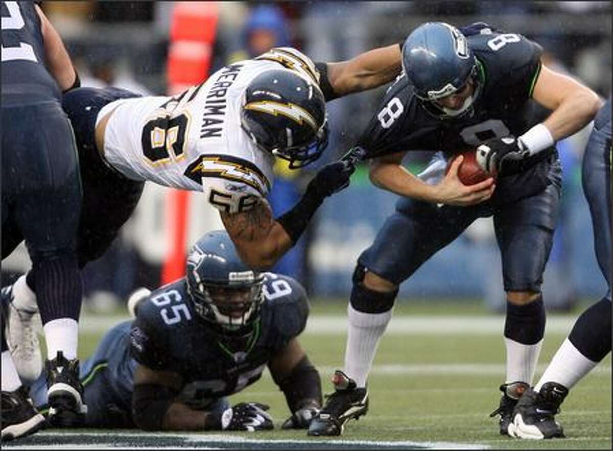 Seahawks quarterback Matt Hasselbeck is sacked by San Diego Chargers linebacker Shawne Merriman (56) for a loss of five yards during first quarter action.