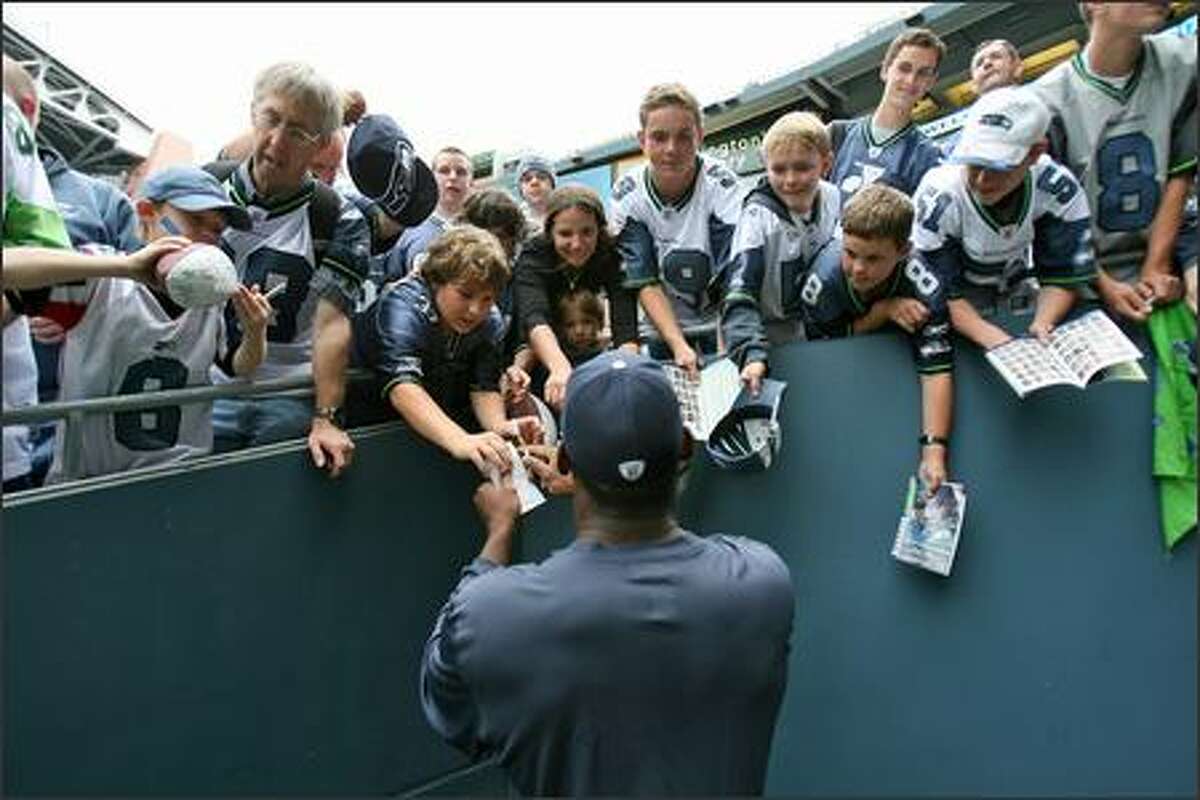 Seattle Seahawks tight end Marcus Pollard (88) signs for the fans prior to the Seahawks game against the Minnesota Vikings at Qwest Field in Seattle, Wash., Saturday August 24, 2007.
