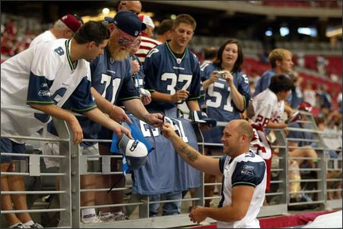 Seattle Seahawks kicker Josh Brown signs autographs for fans before Seattle's game at the University of Phoenix Stadium in Glendale, AZ.