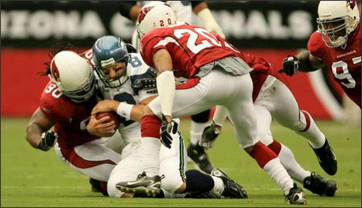 Seattle Seahawks quarterback Matt Hasselbeck is hit by defensive tackle Darnell Dockett after scrambling for 6 yards in the 1st quarter.