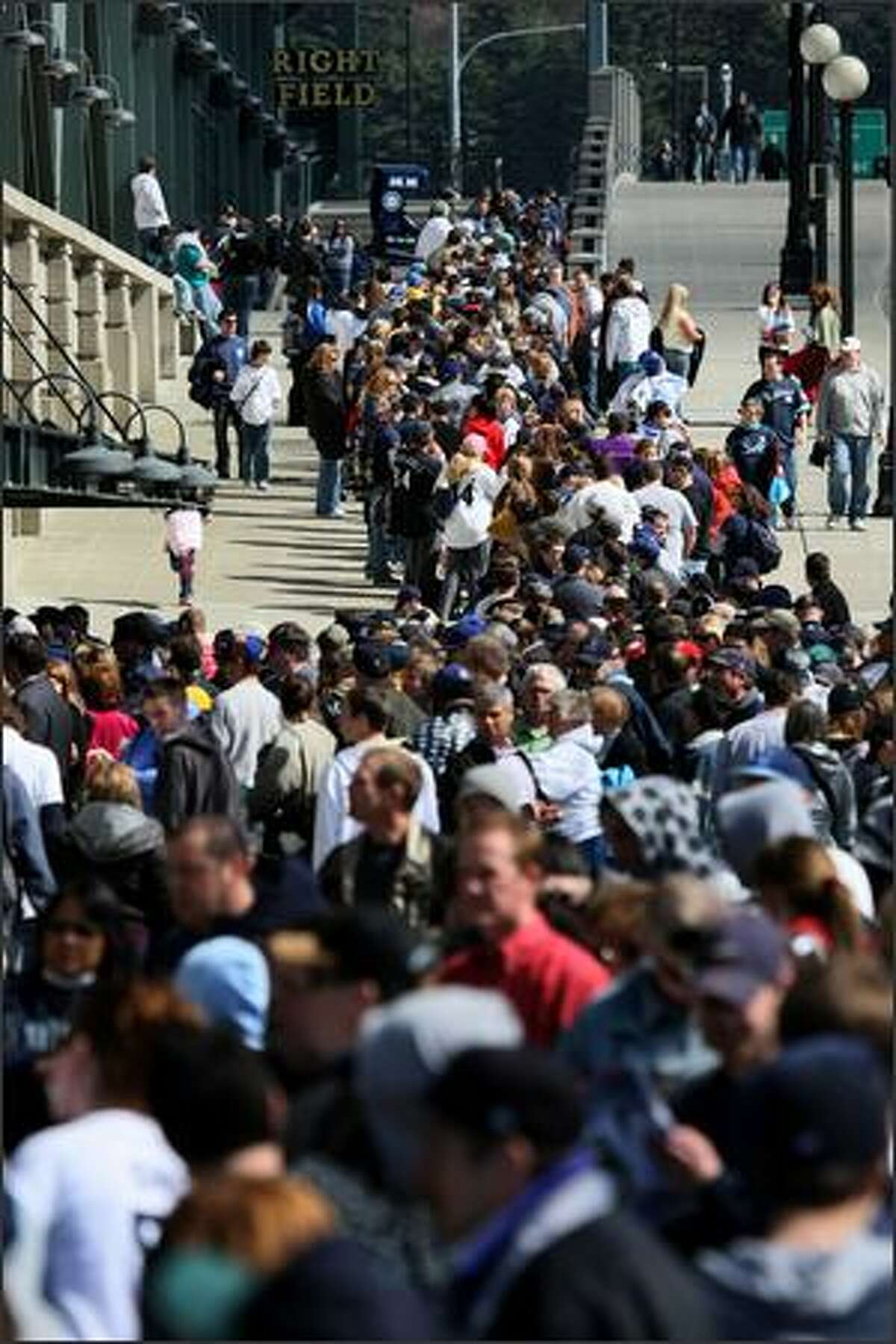 Fans line up to get into Safeco Field during the Seattle Mariners season opener at Safeco in Seattle.