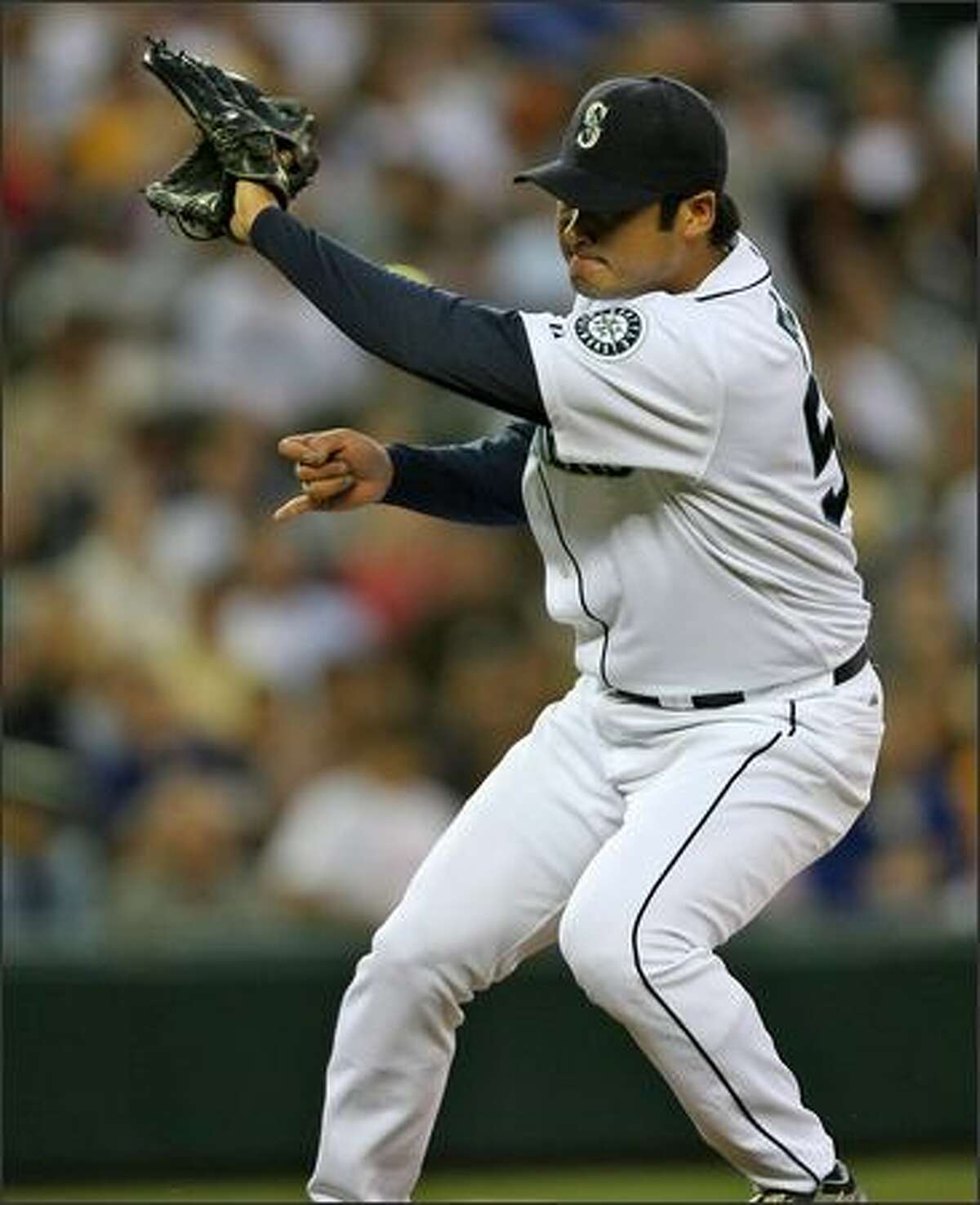 Seattle Mariners Cha Seung Baek stops a hard grounder from Texas Rangers' Marlon Byrd during the sixth inning at Safeco Field.