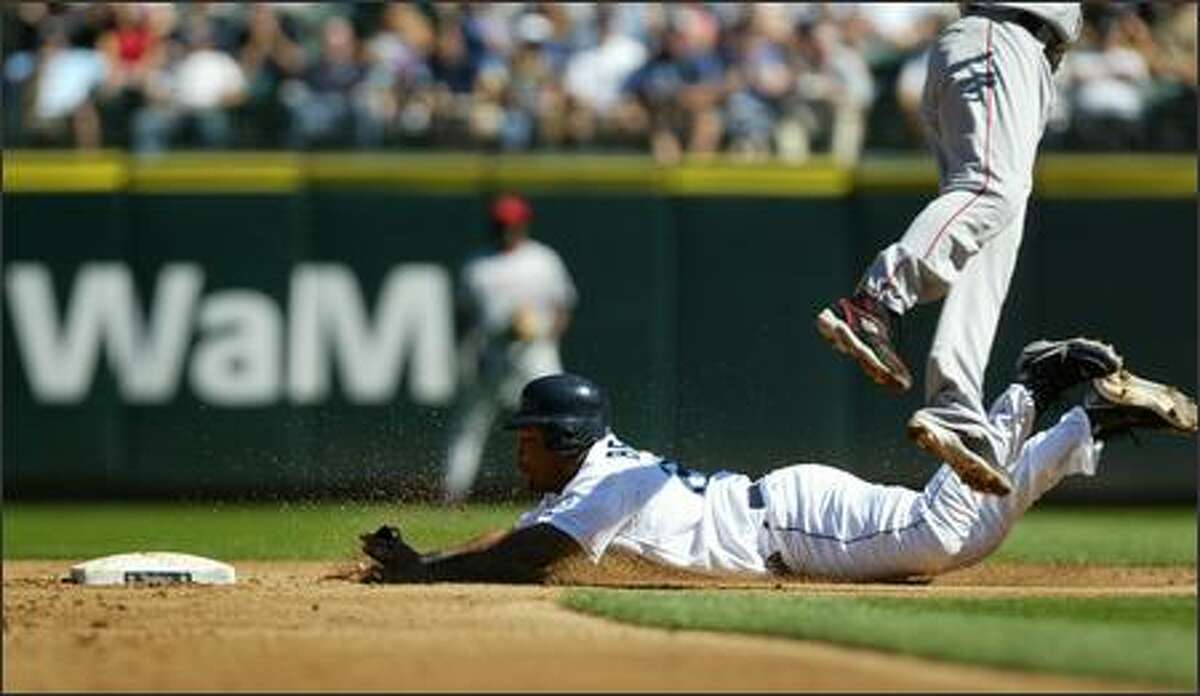 Seattle Mariners player Adrian Beltre steals second as Los Angeles Angels shortstop Orlando Cabrera leaps and misses an overthrown ball on Wednesday, August 29, 2007 at Safeco Field during the second inning in Seattle. Beltre made it to third.