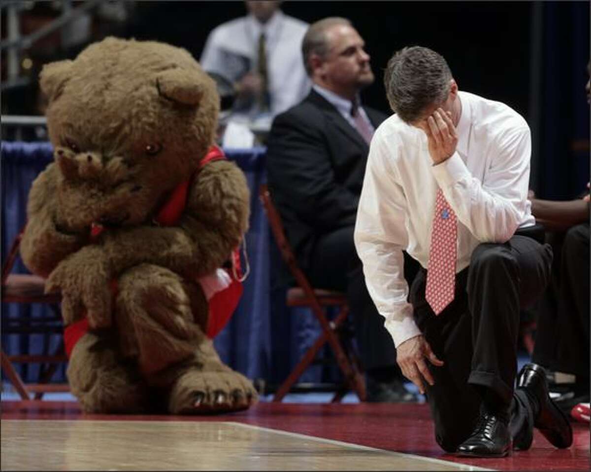 Cornell coach Steve Donahue, right, and the team's unofficial mascot, Big Red Bear, take the same position on the floor during the first half of their first round basketball game at the NCAA South Regional in Anaheim, Calif. AP Photo/Matt Sayles