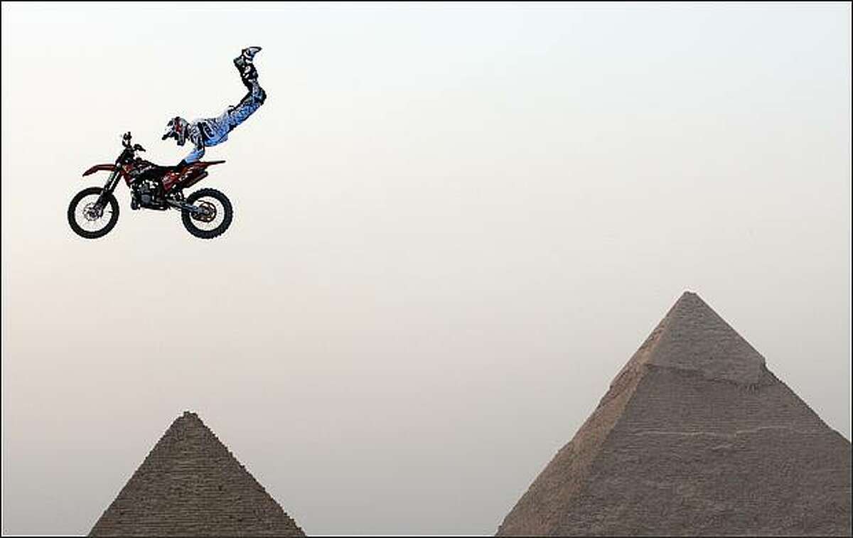 A biker performs in front of the Great Giza pyramids during Red Bull Fighters International Freestyle Motocross 2009 Exhibition Tour on the outskirts of Cairo on April 10.