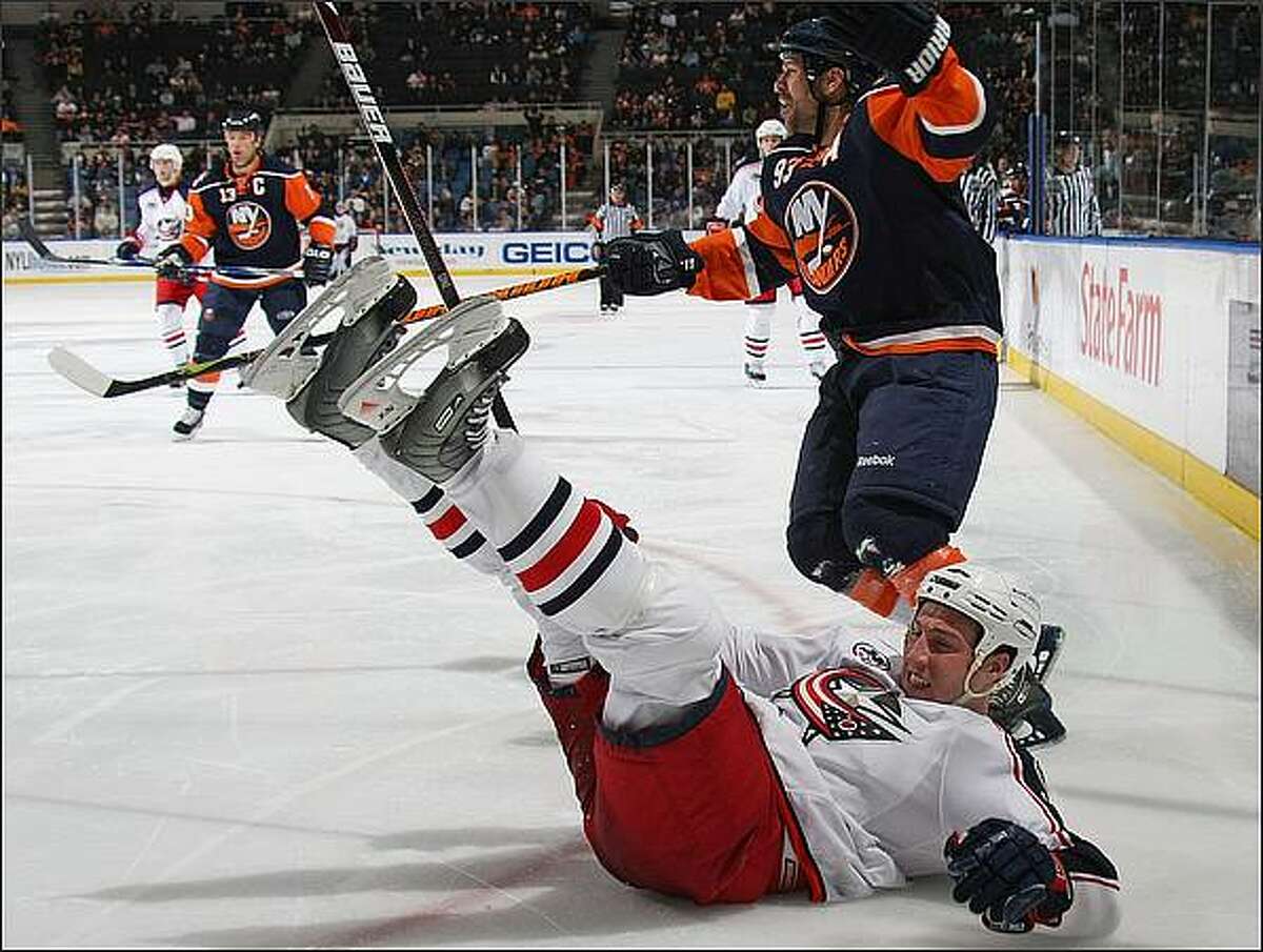 Doug Weight #93 of the New York Islanders takes a two minute penalty for interference against R.J. Umberger #18 of the Columbus Blue Jackets at the Nassau Coliseum in Uniondale, New York. The Islanders defeated the Blue Jackets 4-3 in overtime. (Photo by Bruce Bennett/Getty Images)
