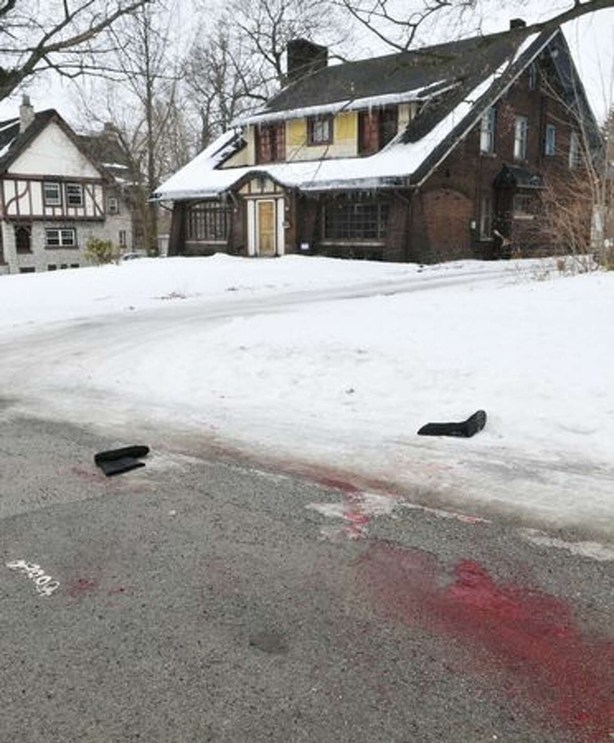 What appears to be blood stains the street near the scene of an early morning shooting at a house just north of the Youngstown State University campus that left student Jamail E. Johnson, 25 of Youngstown, dead and 11 injured, In Youngstown, Ohio on Sunday. (AP Photo/Mark Stahl)