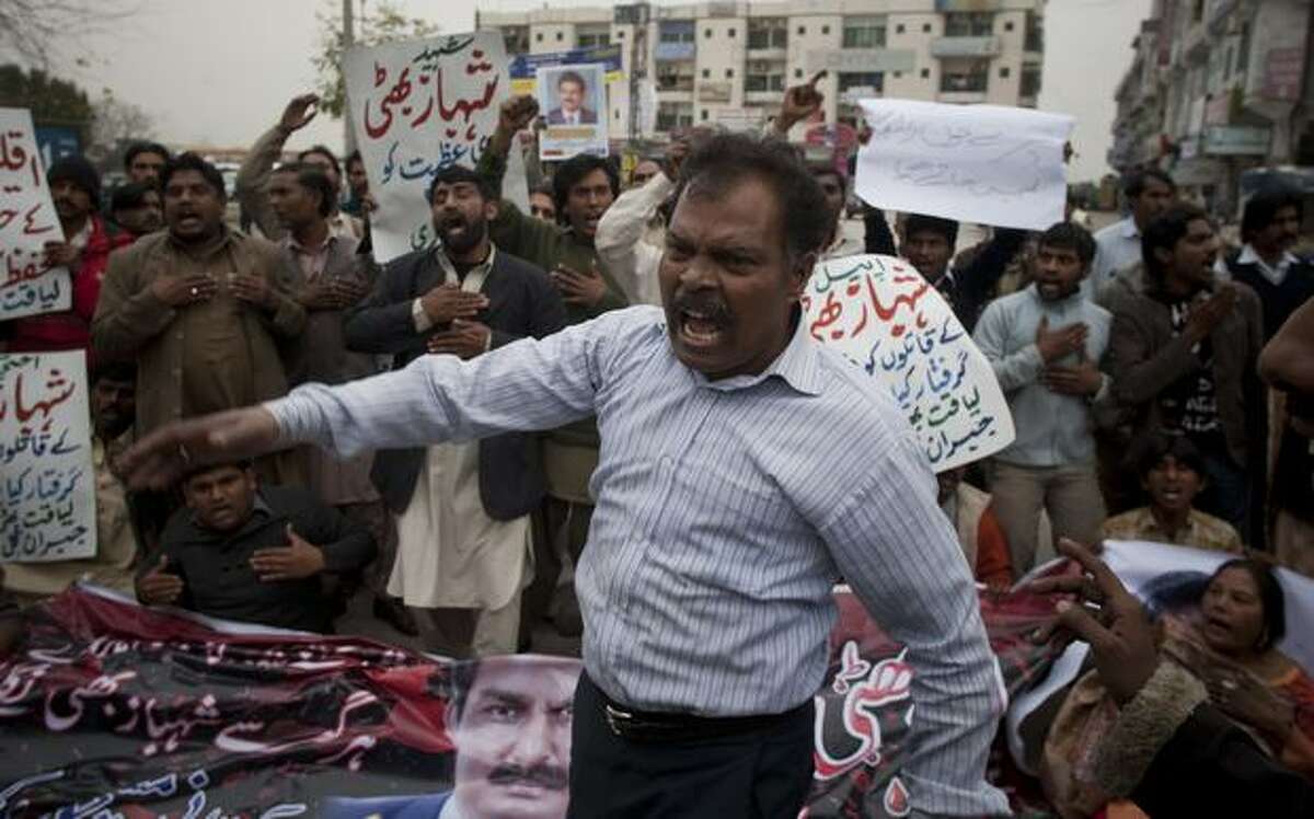 Pakistani Christians rally to protest the killing of their leader and government's minister for minorities Shahbaz Bhatti, outside his home in Islamabad, Pakistan, on Thursday. Hundreds of Christians and others demonstrated against the slaying of a Catholic government minister, demanding justice. (AP Photo/B.K.Bangash)