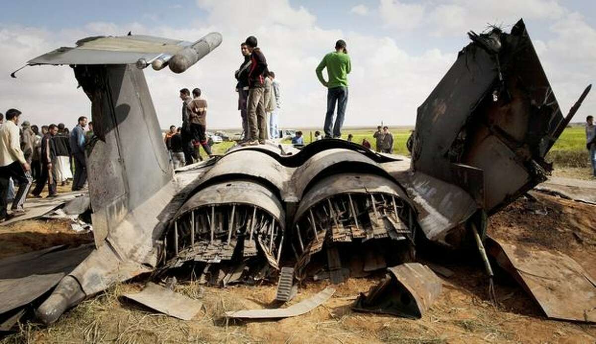 Libyans inspect the wreckage of a U.S. F-15 fighter jet after it crashed in an open field in the village of Bu Mariem, east of Benghazi, eastern Libya, Tuesday, March 22, 2011, with both crew ejecting safely. The U.S. Africa Command said both crew members were safe after what was believed to be a mechanical failure of the Air Force F-15. The aircraft, based out of Royal Air Force Lakenheath, England, was flying out of Italy's Aviano Air Base in support of Operation Odyssey Dawn.(AP Photo/Anja Niedringhaus)