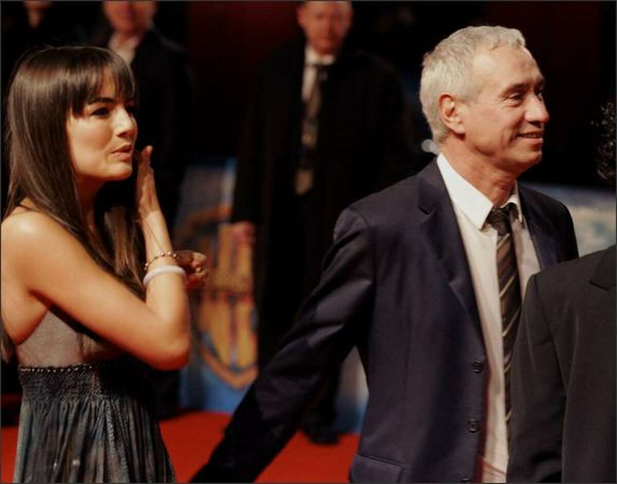 Movie star Camilla Belle, left, and director Roland Emmerich, right, pose prior to their premiere of the movie "10,000 B.C." in Berlin on Tuesday. (AP Photo/Fritz Reiss)