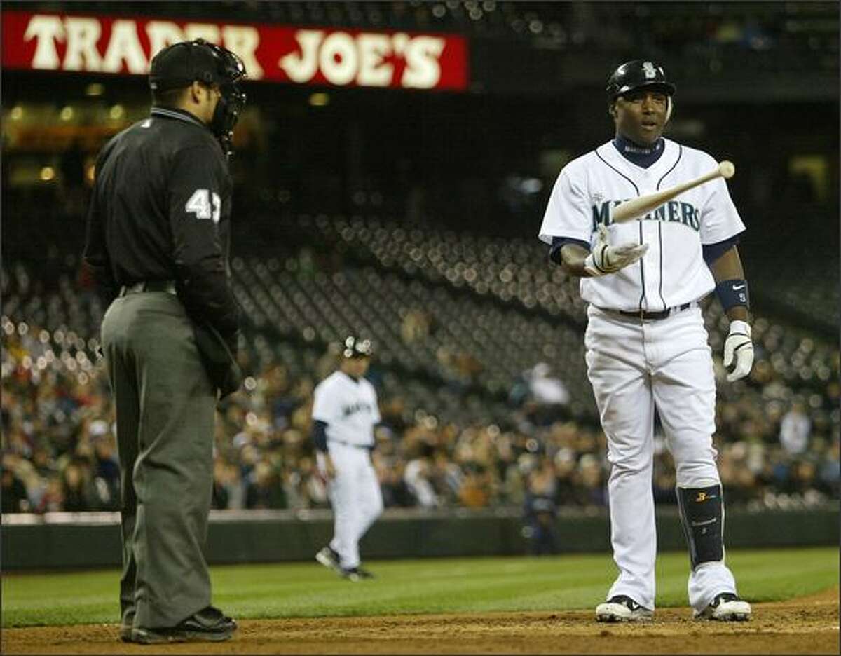 Seattle Mariners Yuniesky Betancourt is called out on strikes by home plate umpire Mark Wegner.