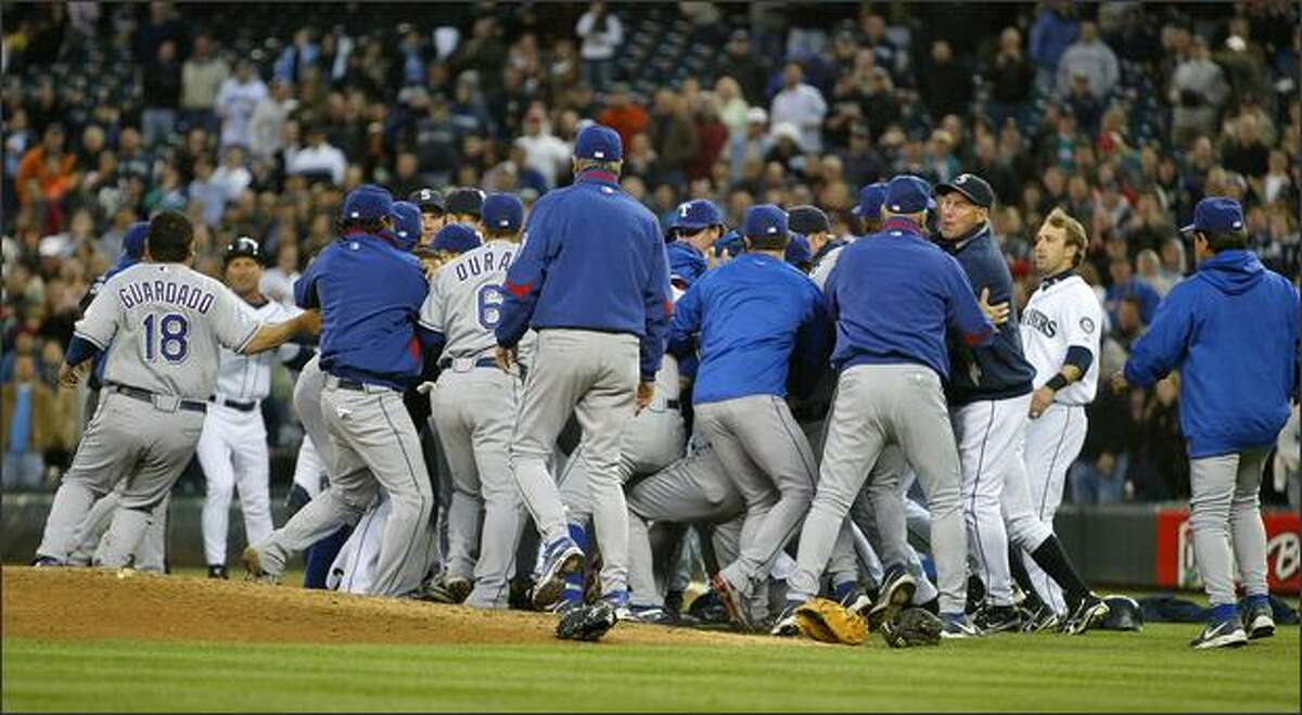 Players from both teams surround the mound where Richie Sexson sparked a bench-clearing melee with the Texas Rangers by tackling Texas pitcher Kason Gabbard in the fourth inning.