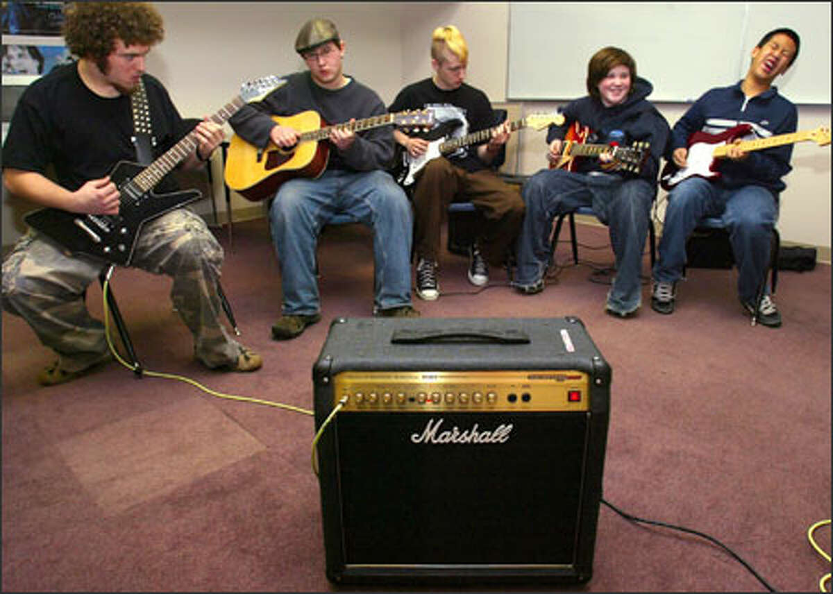 Students in the Rock School intermediate guitar class practice the intro riff to Led Zeppelin's "Dazed and Confused" at BEST High School in Kirkland. From left are Kurt Hamilton, 16; Matt Maier, 15; Dylan Simpson, 16; Callum Dickson, 13; and David Du, 13. Rock School is a non-profit corporation that provides training for musicians ages 12 to 21. Based in Kirkland, it is expanding to include classes in the basement of the Vera Project, a community center in Seattle that produces live music and arts performances. More information: www.rock-school.org