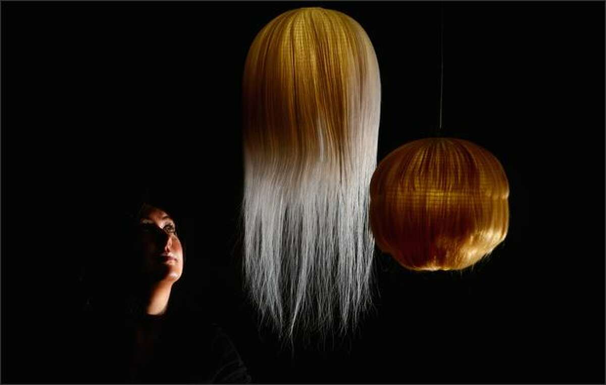 Claire Neil looks at a series of Japanese lanterns made from hair, by fashion designer Kosuke Tsmura, which is part of an exhibition at The Lighthouse on Tuesday in Glasgow, Scotland. Haptic, is an exhibition from the Nippon Design Museum, Tokyo, and gets its only Scottish showing at The Lighthouse from 18 June 2008.