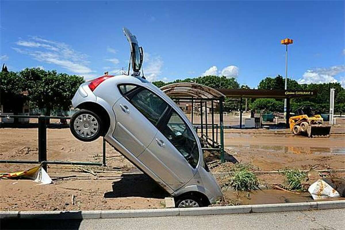 The worst flooding in two centuries in France's Cote d'Azur region killed at least 25 people and stood this hatchback on its nose in a supermarket parking lot.