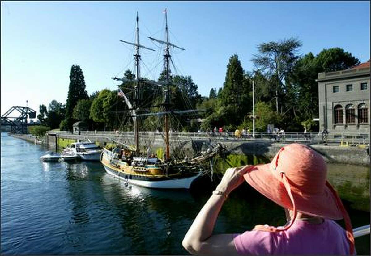 The tall ship "Lady Washington," owned and operated by the Grays Harbor Historical Seaport Authority, travels through the Ballard Locks on its way to Lake Union on Monday as Molly Bonhag of New Hampshire looks on. There will be free dockside tours of the ship as well as three-hour sailings through Sunday on Lake Union.